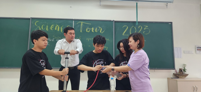 A group of people standing in front of a chalkboardDescription automatically generated with medium confidence