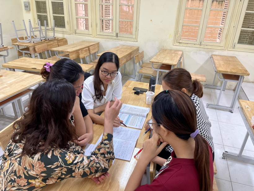 A group of people sitting around a tableDescription automatically generated