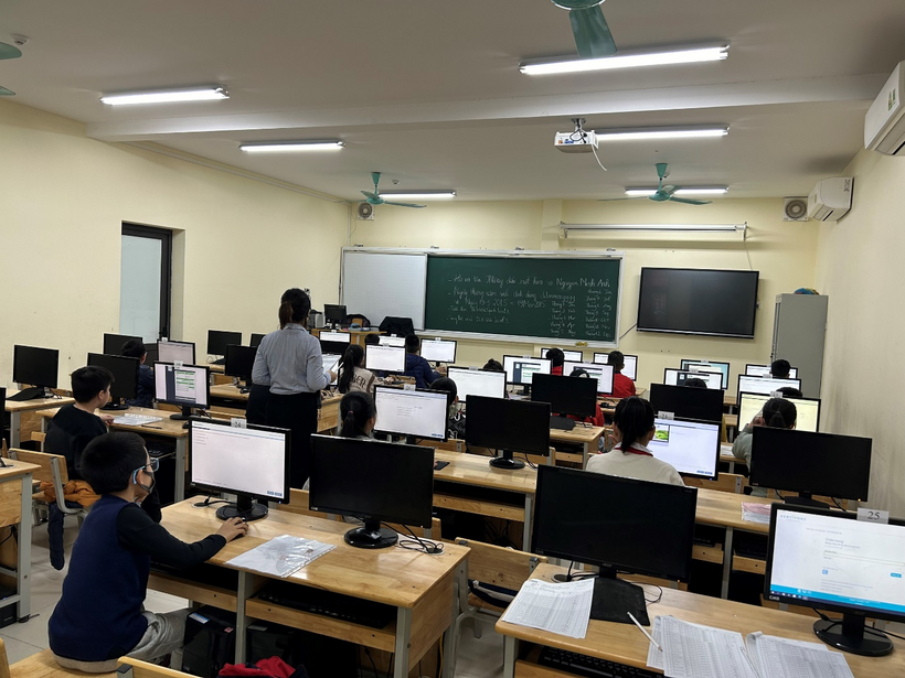 A group of people in a classroom with computersDescription automatically generated