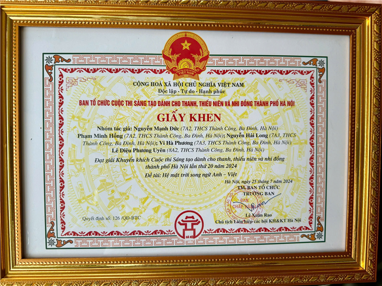 A certificate in a gold frame

Description automatically generated