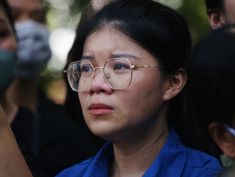 A person wearing glasses looking up

Description automatically generated