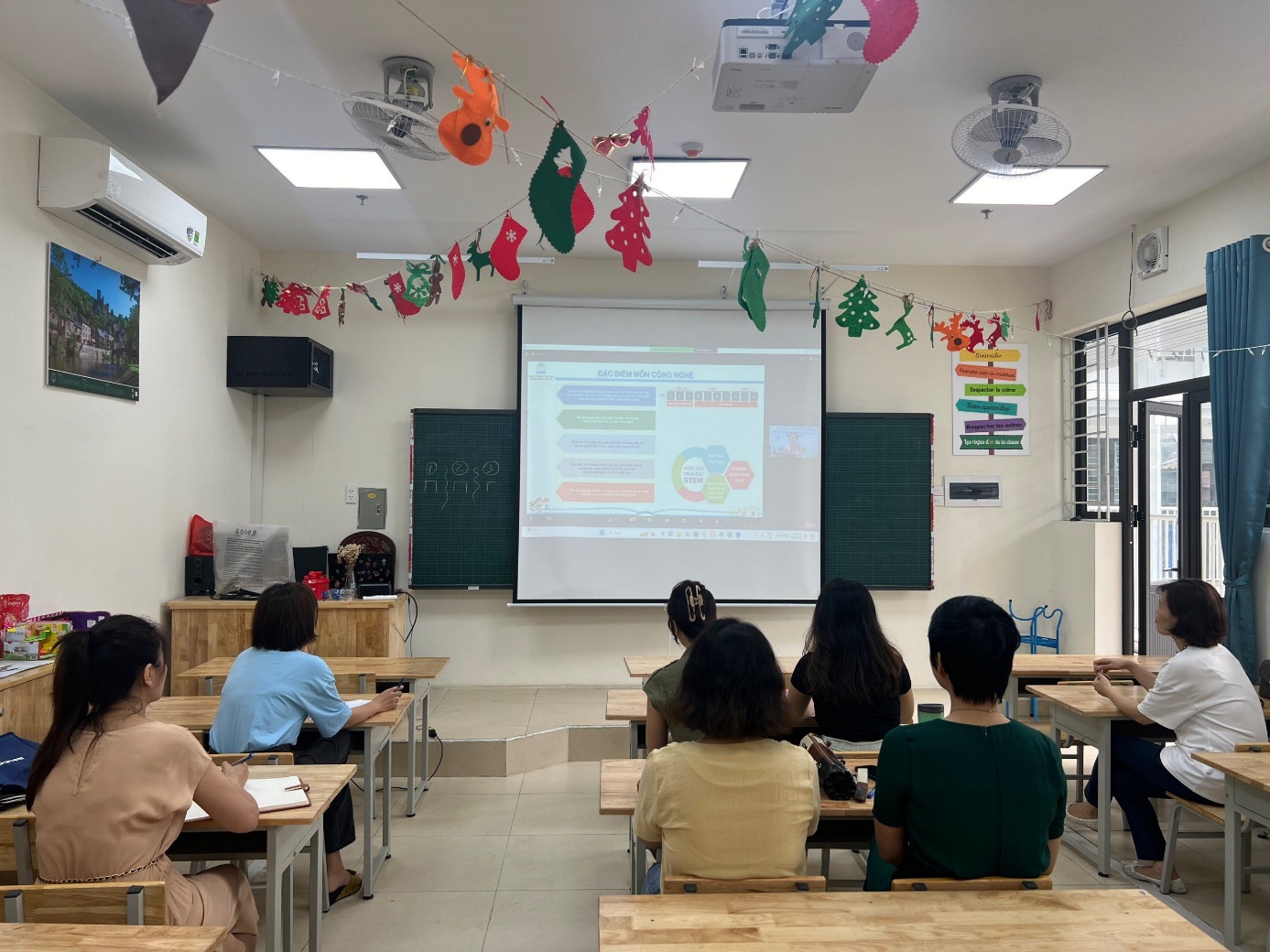A group of people sitting in a classroom

Description automatically generated