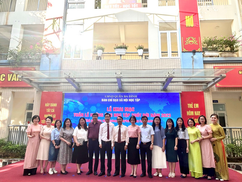 A group of people standing in front of a buildingDescription automatically generated