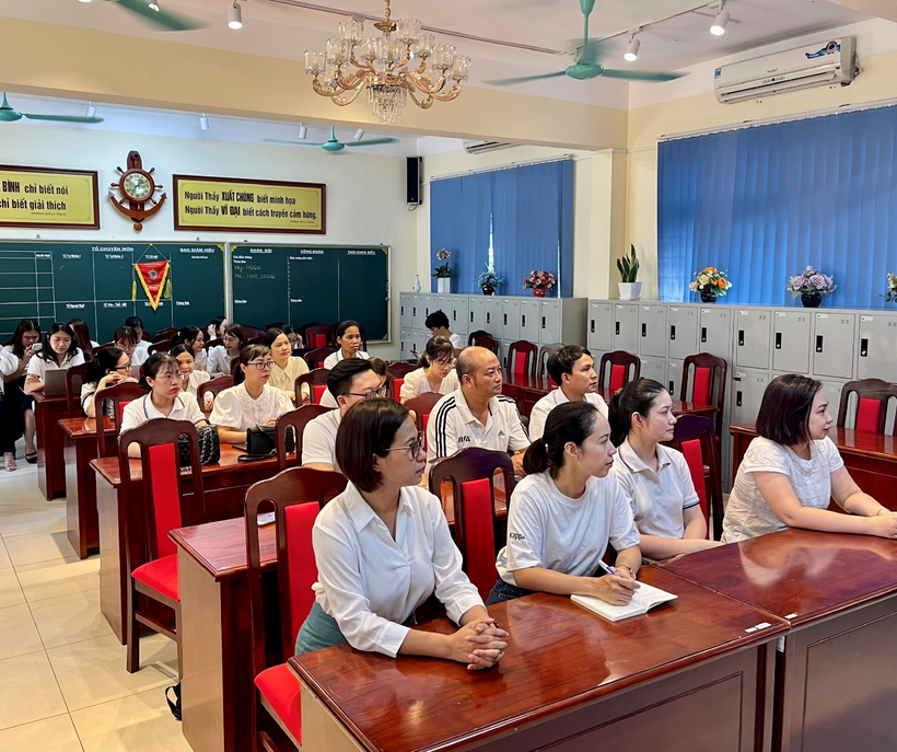 A group of people sitting at desks in a classroomDescription automatically generated