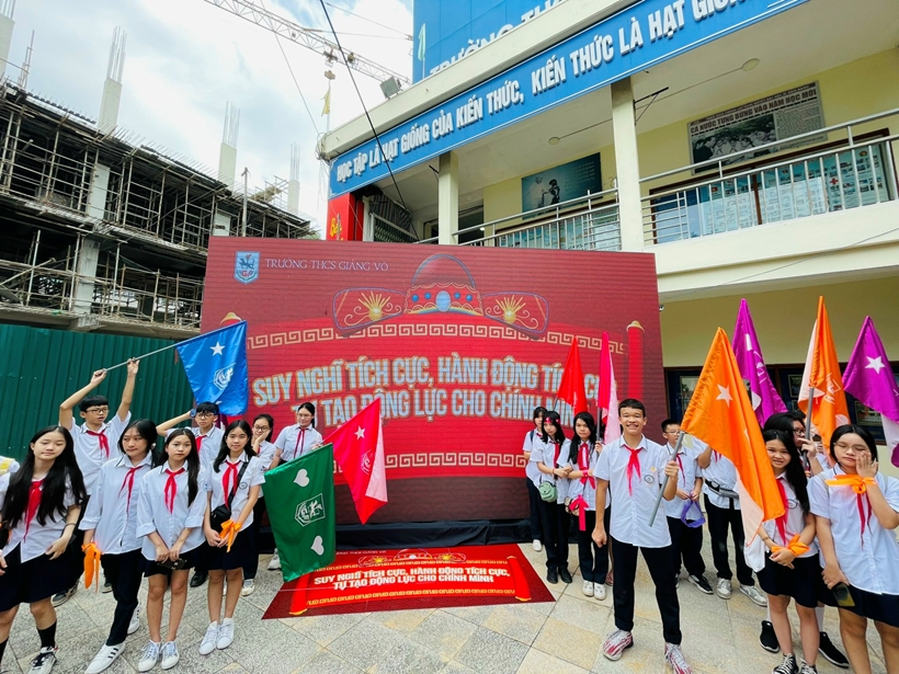 A group of people holding flags

Description automatically generated