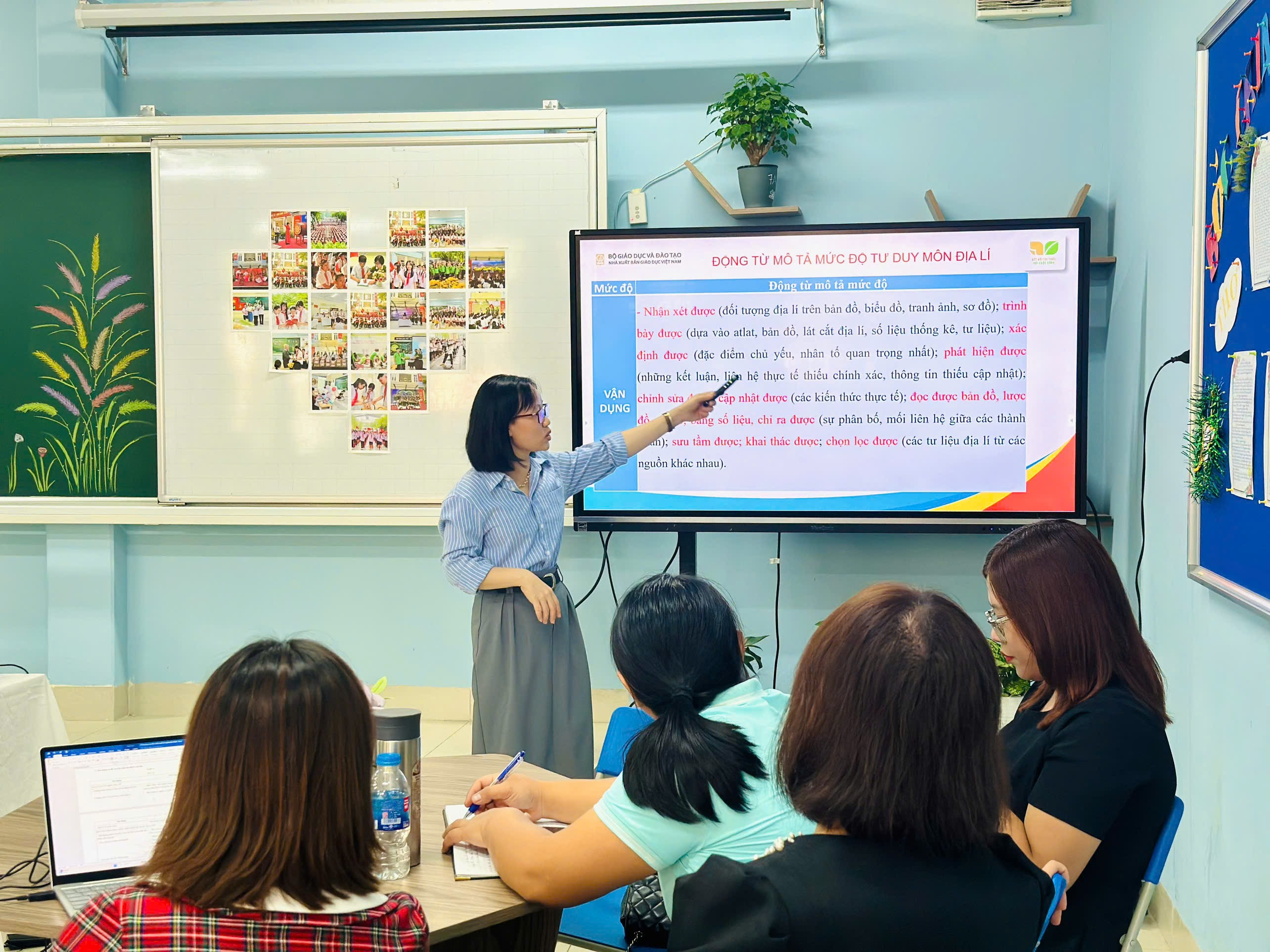 A person standing in front of a large screenDescription automatically generated