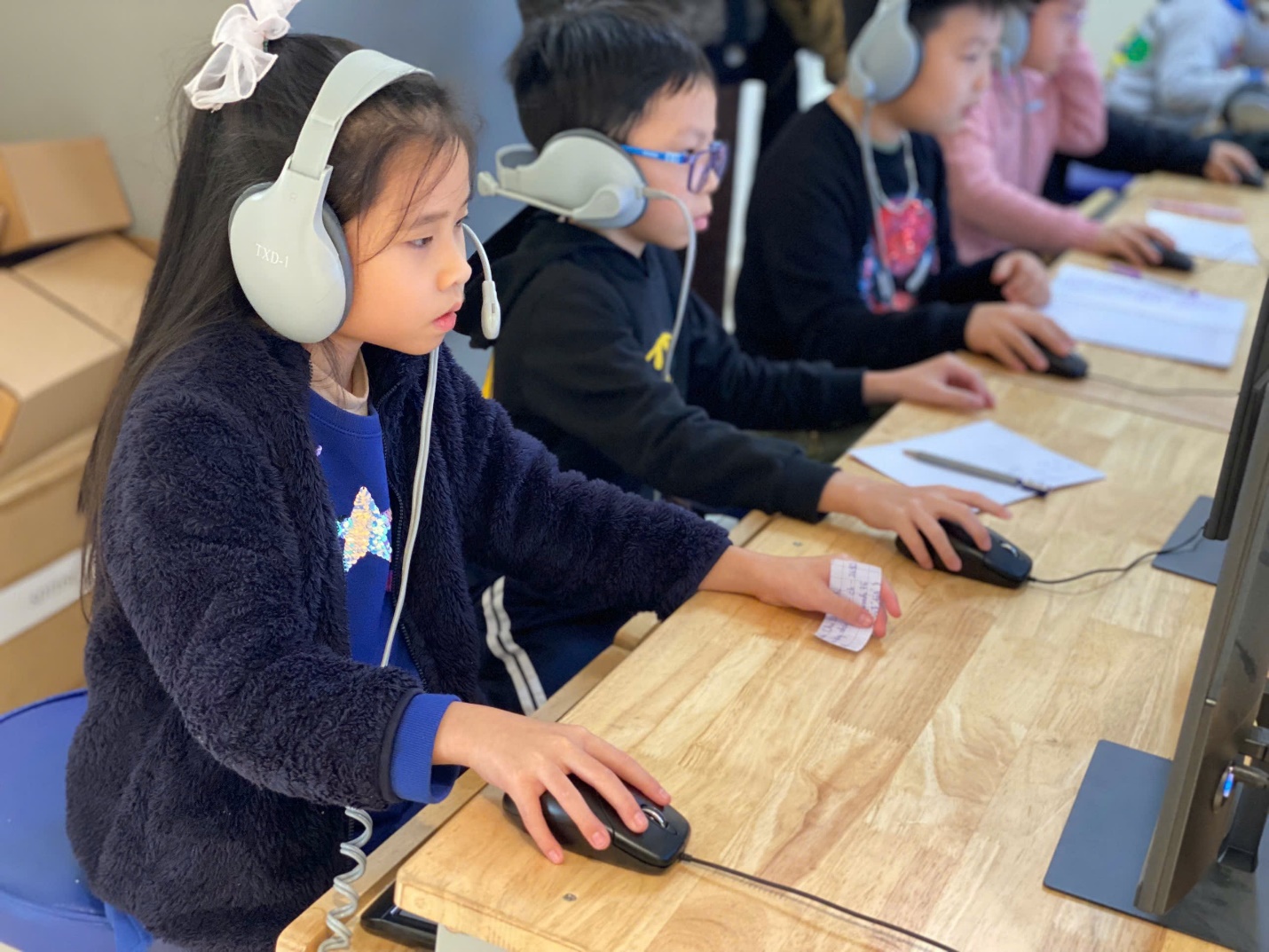 A group of children using computers

AI-generated content may be incorrect.