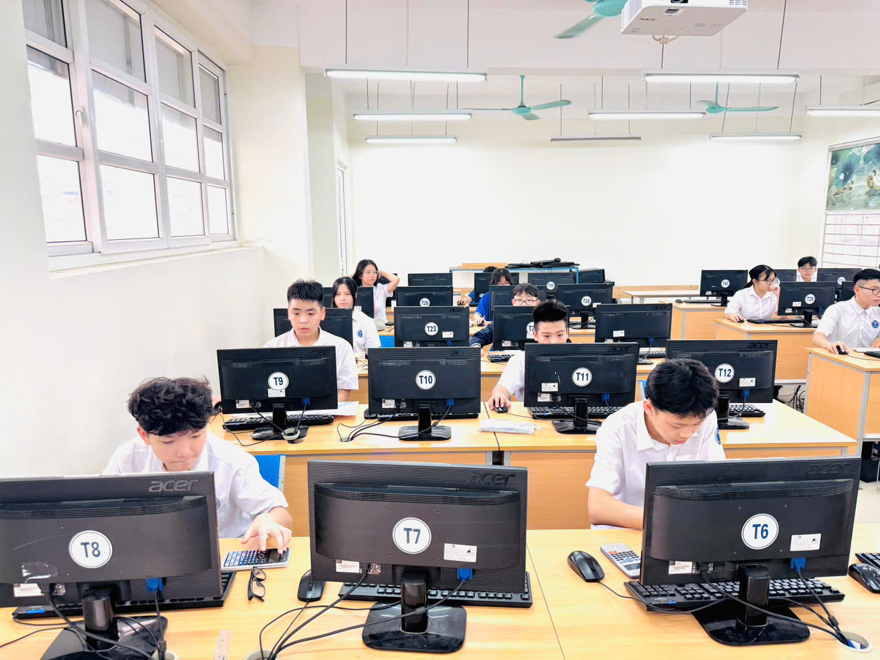 A group of people in a classroom using computers
AI-generated content may be incorrect.