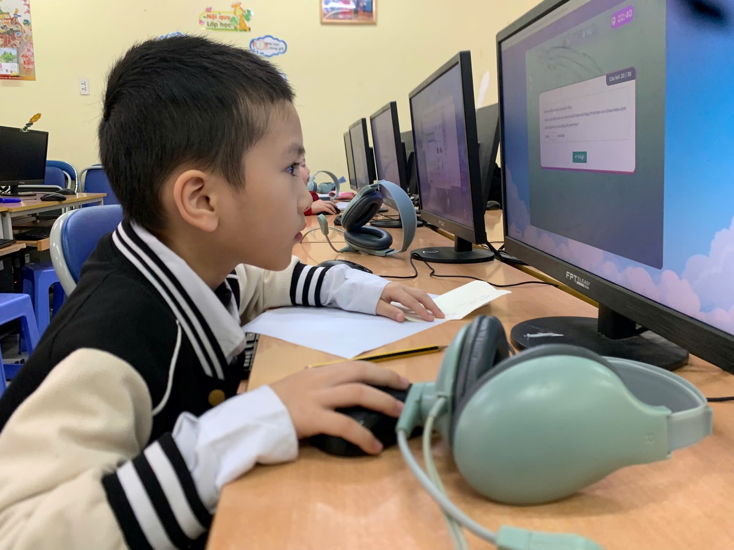 A child sitting at a desk with a computer
AI-generated content may be incorrect.