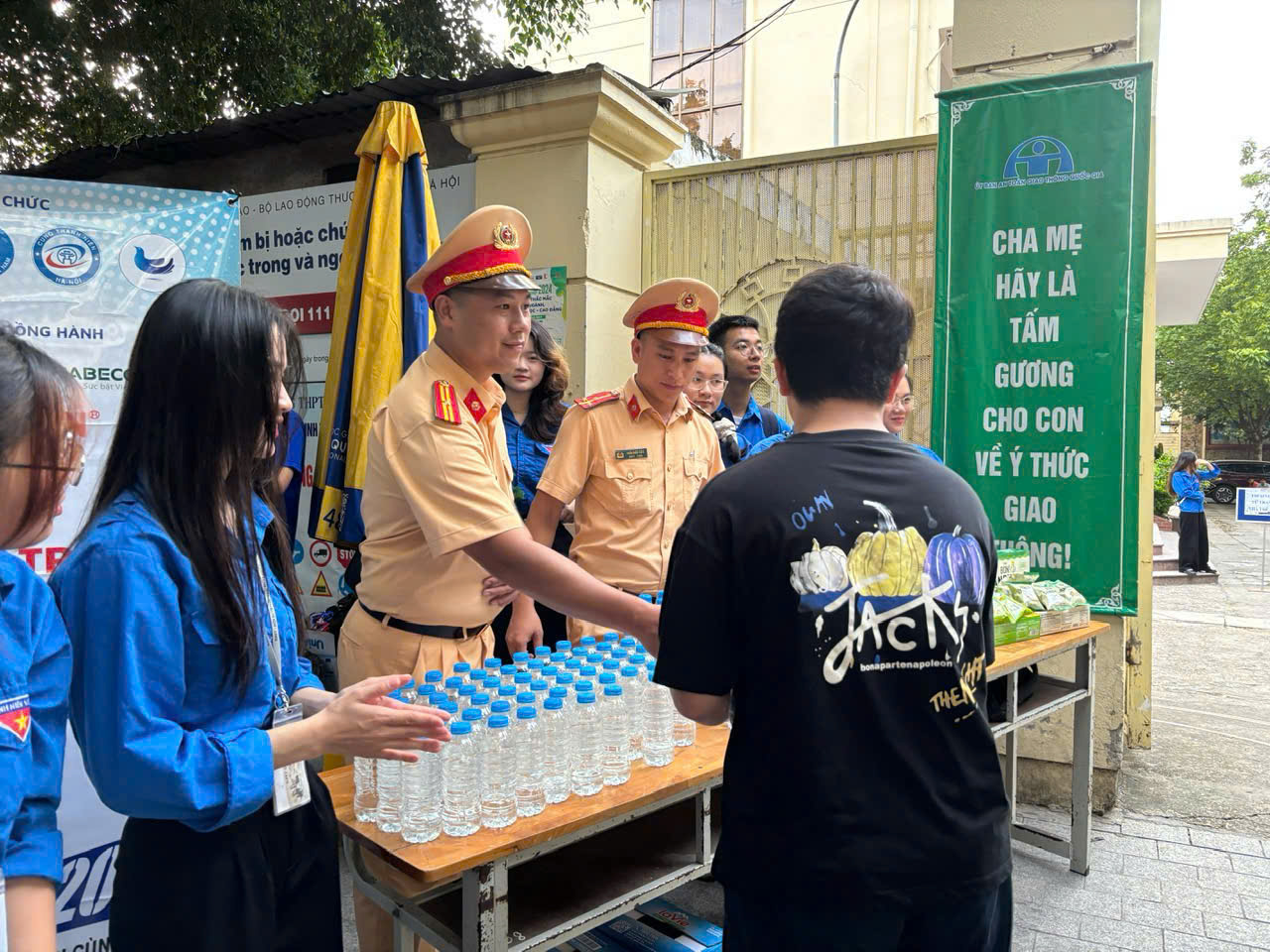 A group of people standing around a table with water bottles

AI-generated content may be incorrect.