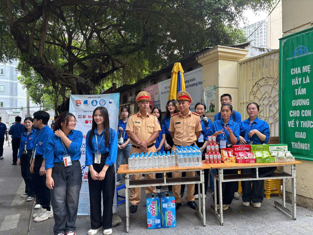 A group of people standing next to a table of drinks

AI-generated content may be incorrect.