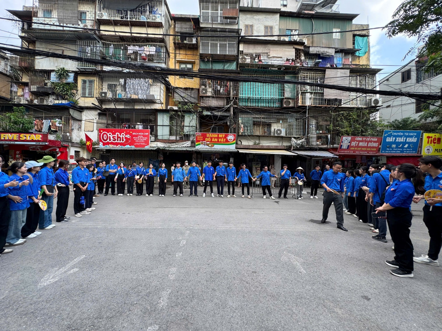 A group of people in blue shirts standing in a circle

AI-generated content may be incorrect.